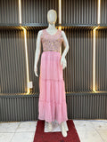 Mannequin wearing a pink dress with a textured top against a modern interior background
