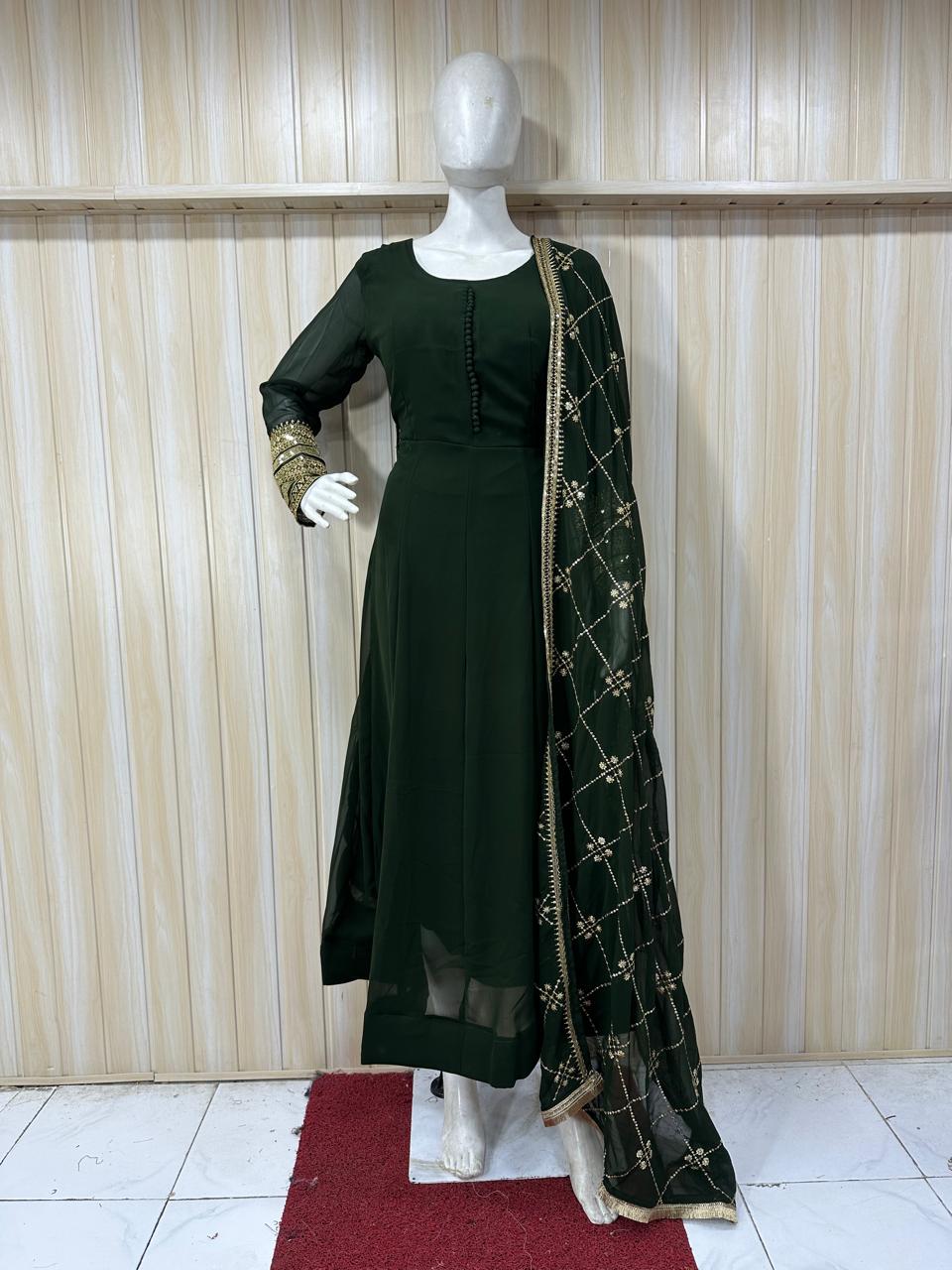 Mannequin wearing a dark green outfit with a matching dupatta against a striped