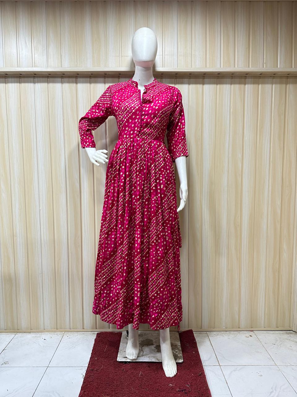 Mannequin wearing a red patterned dress against a striped