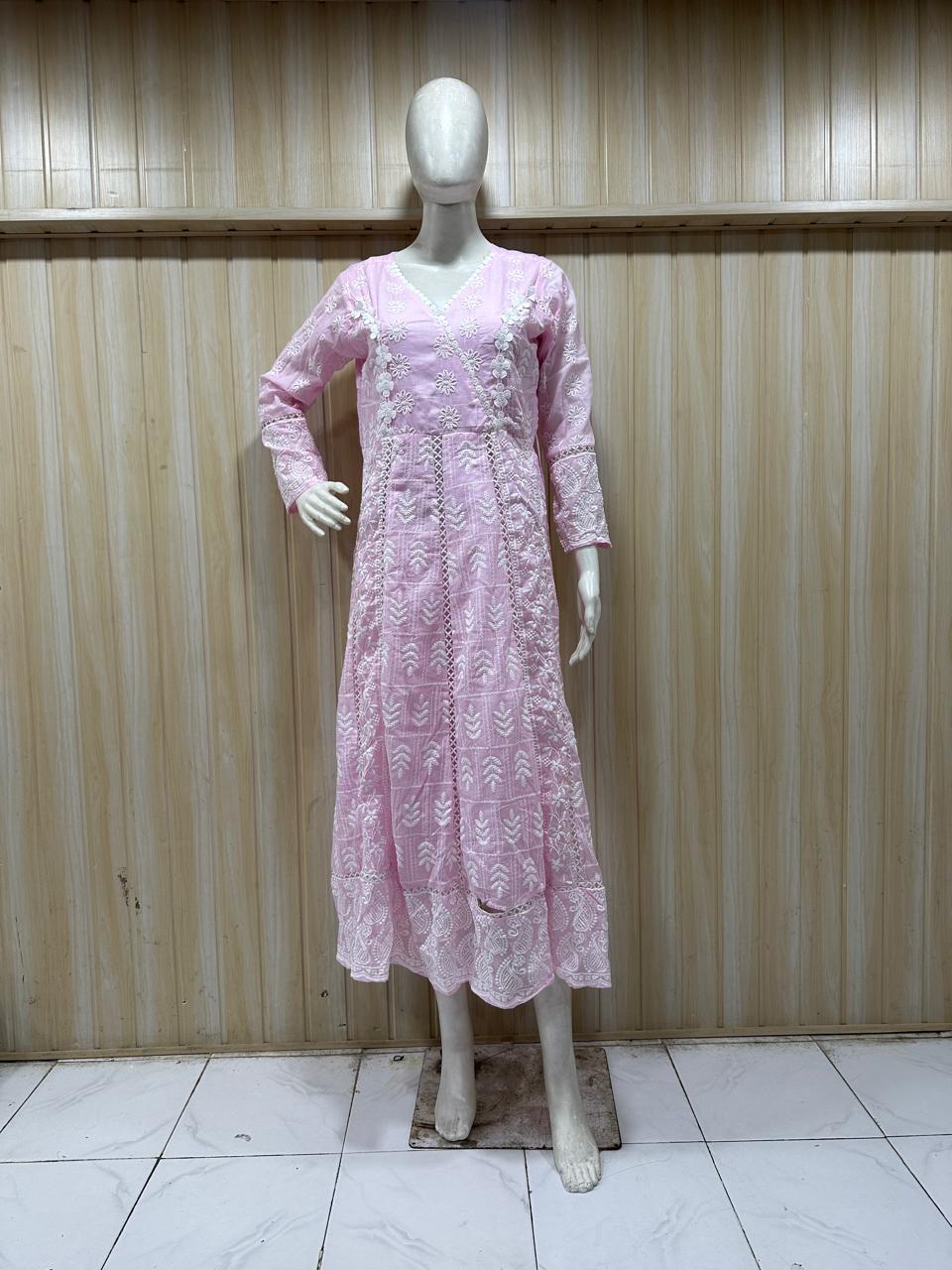 Mannequin wearing a pink lace dress against a striped