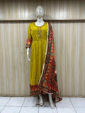 Mannequin wearing a yellow dress with a colorful dupatta against a striped