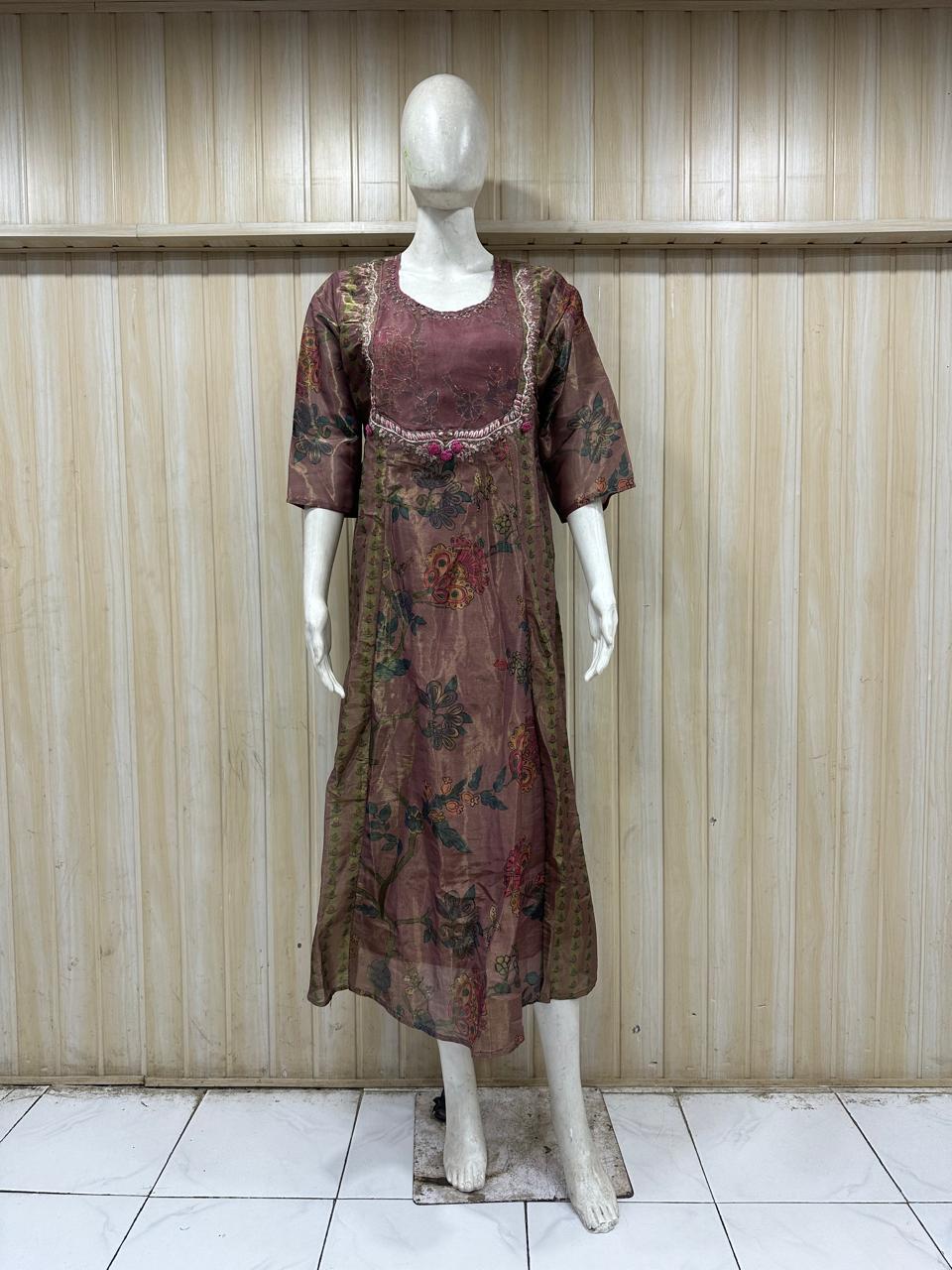 Mannequin wearing a patterned dress against a wooden paneled