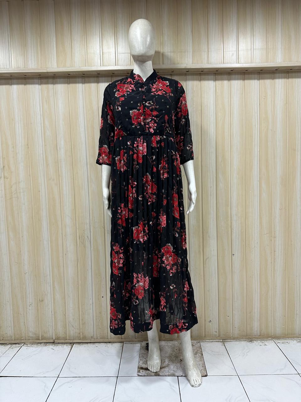 Mannequin wearing a black floral dress against a wooden panel background