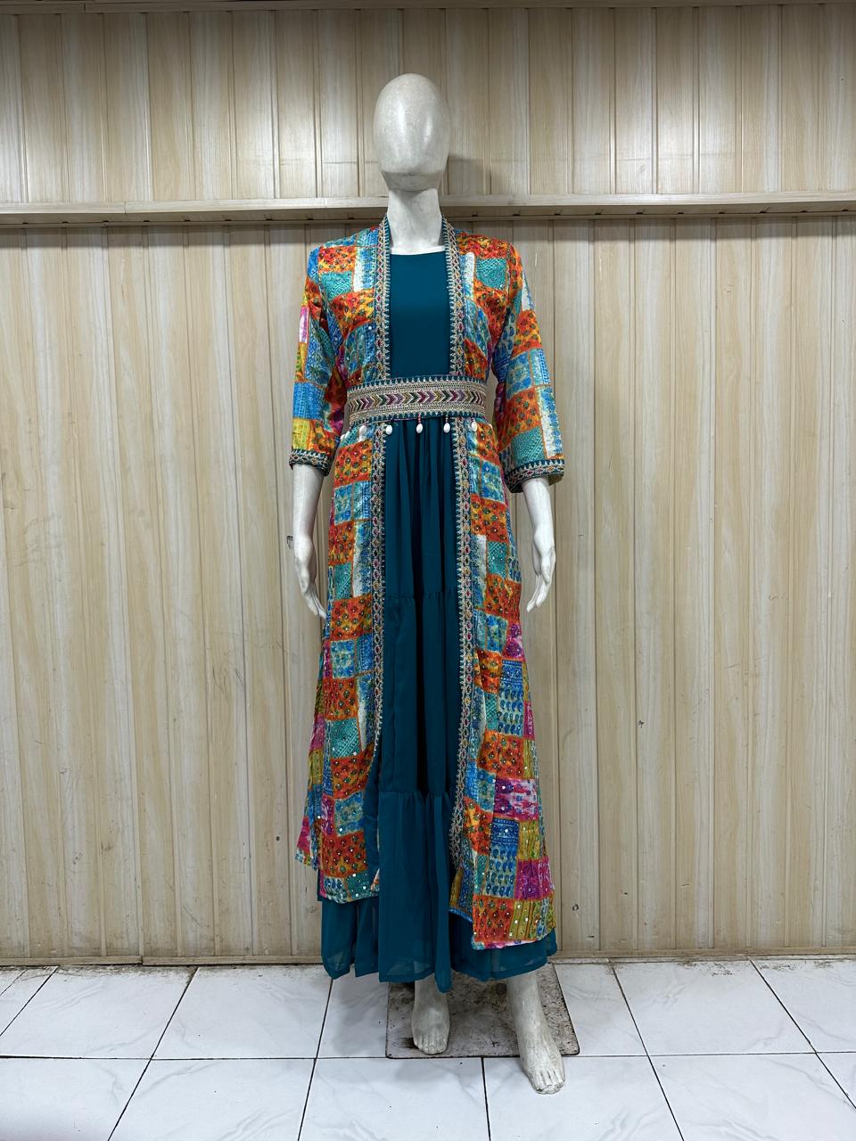 Mannequin wearing a colorful embroidered jacket over a teal dress against a striped