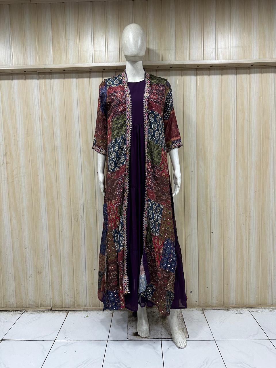 Mannequin wearing a long, patterned coat over a dark dress against a wooden panel background.