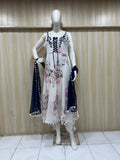 white embroidered dress with  blue matching dupatta on a mannequin against a striped