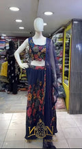 Mannequin wearing a floral dress with a store interior in the background