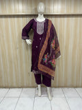 Mannequin wearing a purpal outfit with a colorful scarf against a striped