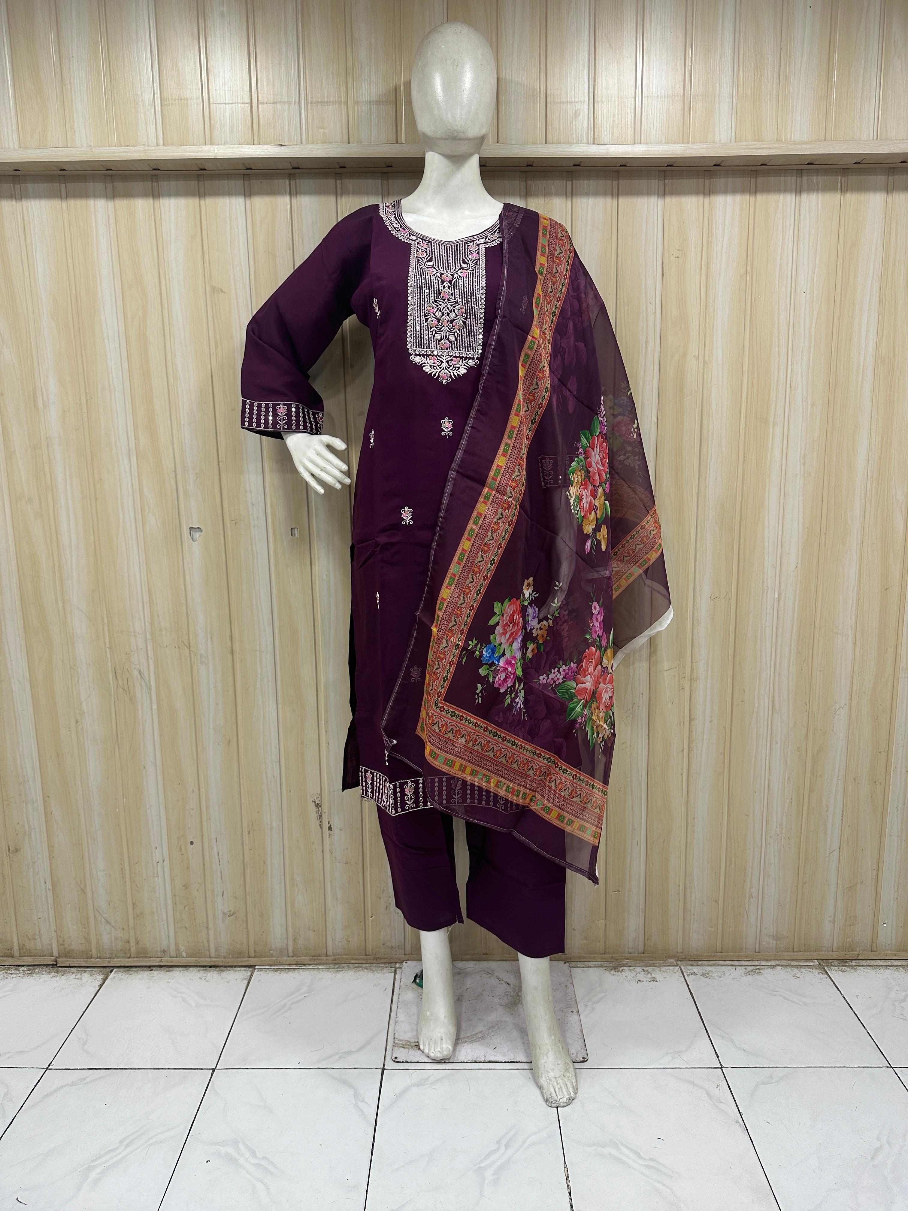 Mannequin wearing a purpal outfit with a colorful scarf against a striped