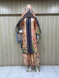 Mannequin wearing a floral dress with a matching headscarf against a striped