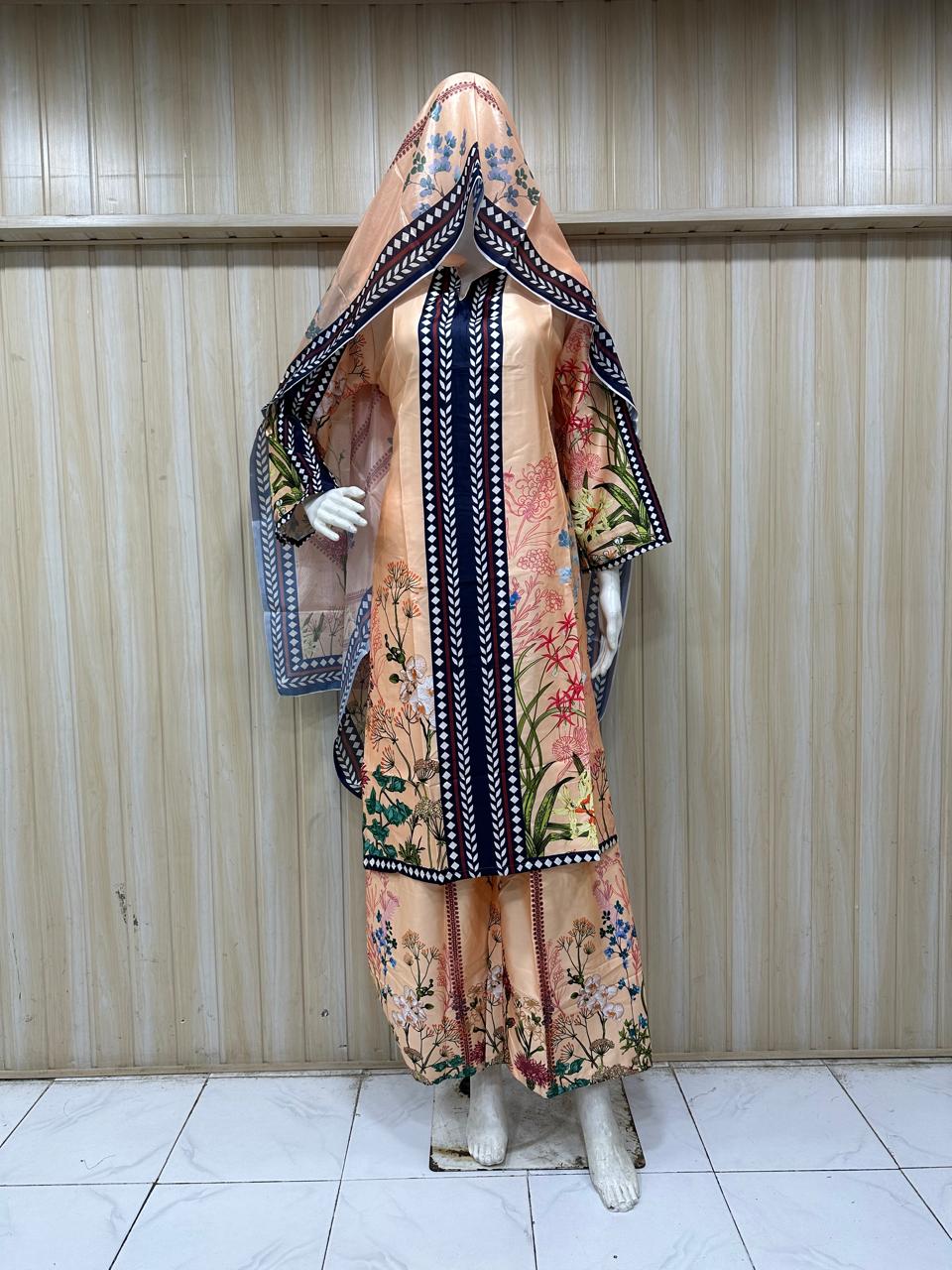 Mannequin wearing a floral dress with a matching headscarf against a striped