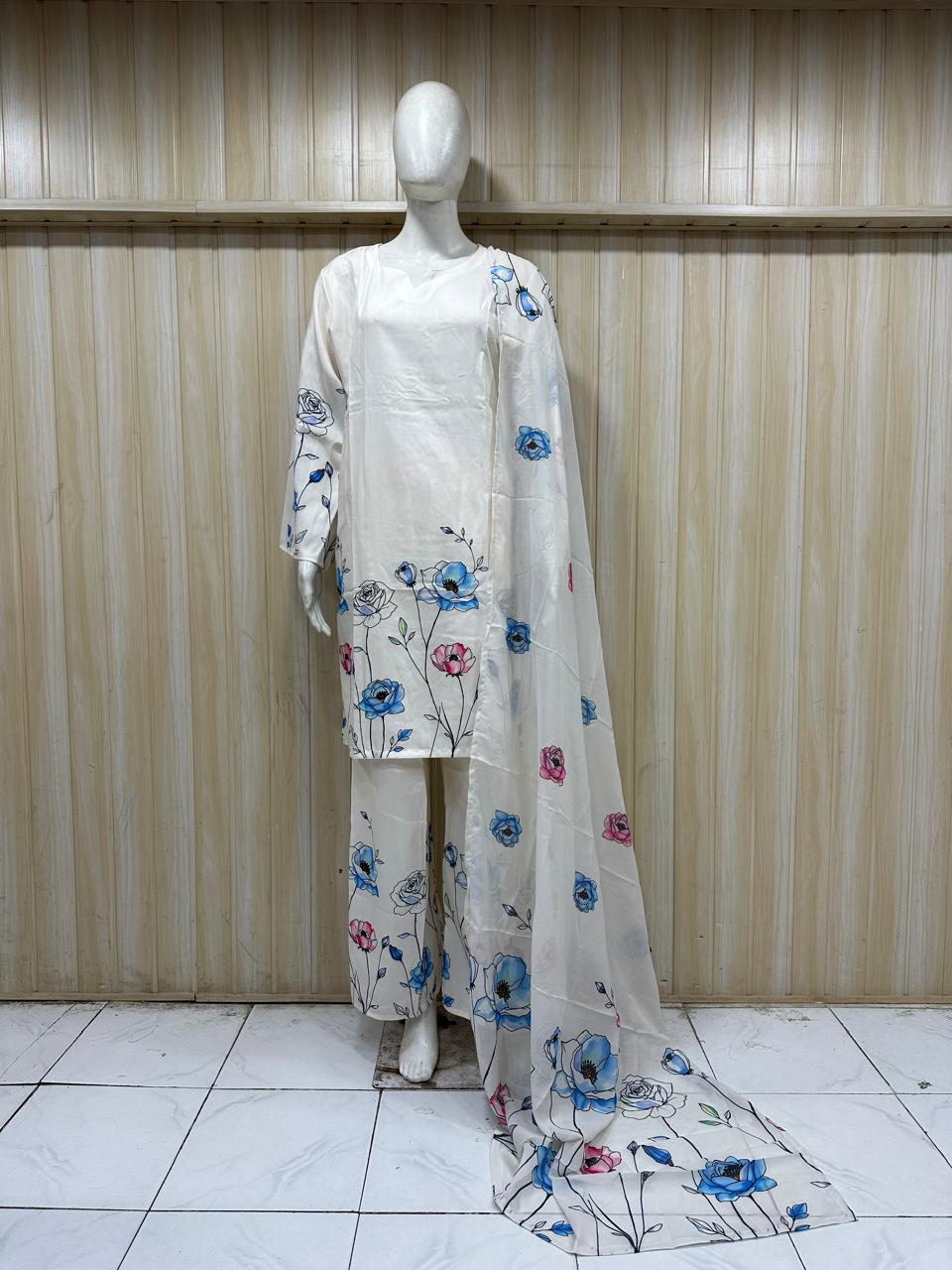 Mannequin wearing a floral outfit with a white background