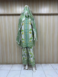 Green and white patterned outfit with a matching headscarf on a wooden background