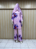 Purple floral outfit on a mannequin against a striped