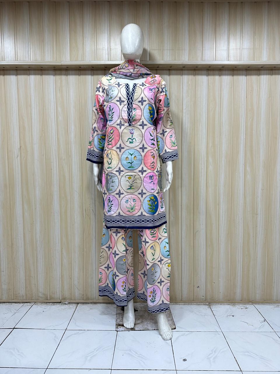 Mannequin wearing a colorful outfit with circular patterns against a striped