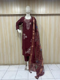 Maroon embroidered outfit with a sheer dupatta on a mannequin against a striped