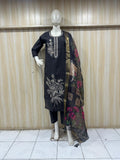 Mannequin wearing a black embroidered dress with a floral dupatta against a striped