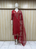 Red embroidered outfit with a dupatta on a mannequin against a striped