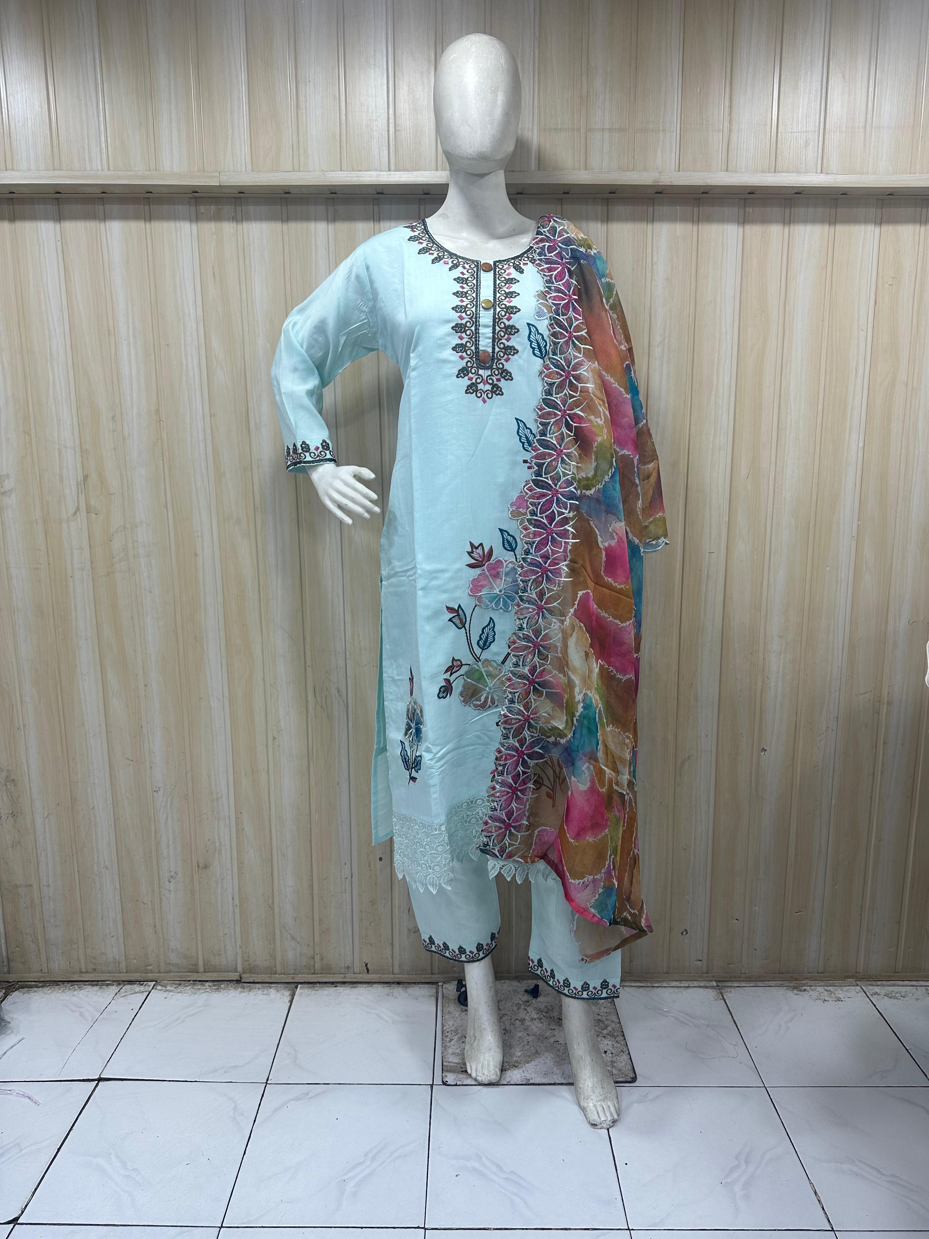 blue embroidered traditional outfit on a colorful dupatta mannequin against a striped