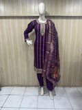 Mannequin wearing a purple traditional outfit with embroidery against a striped