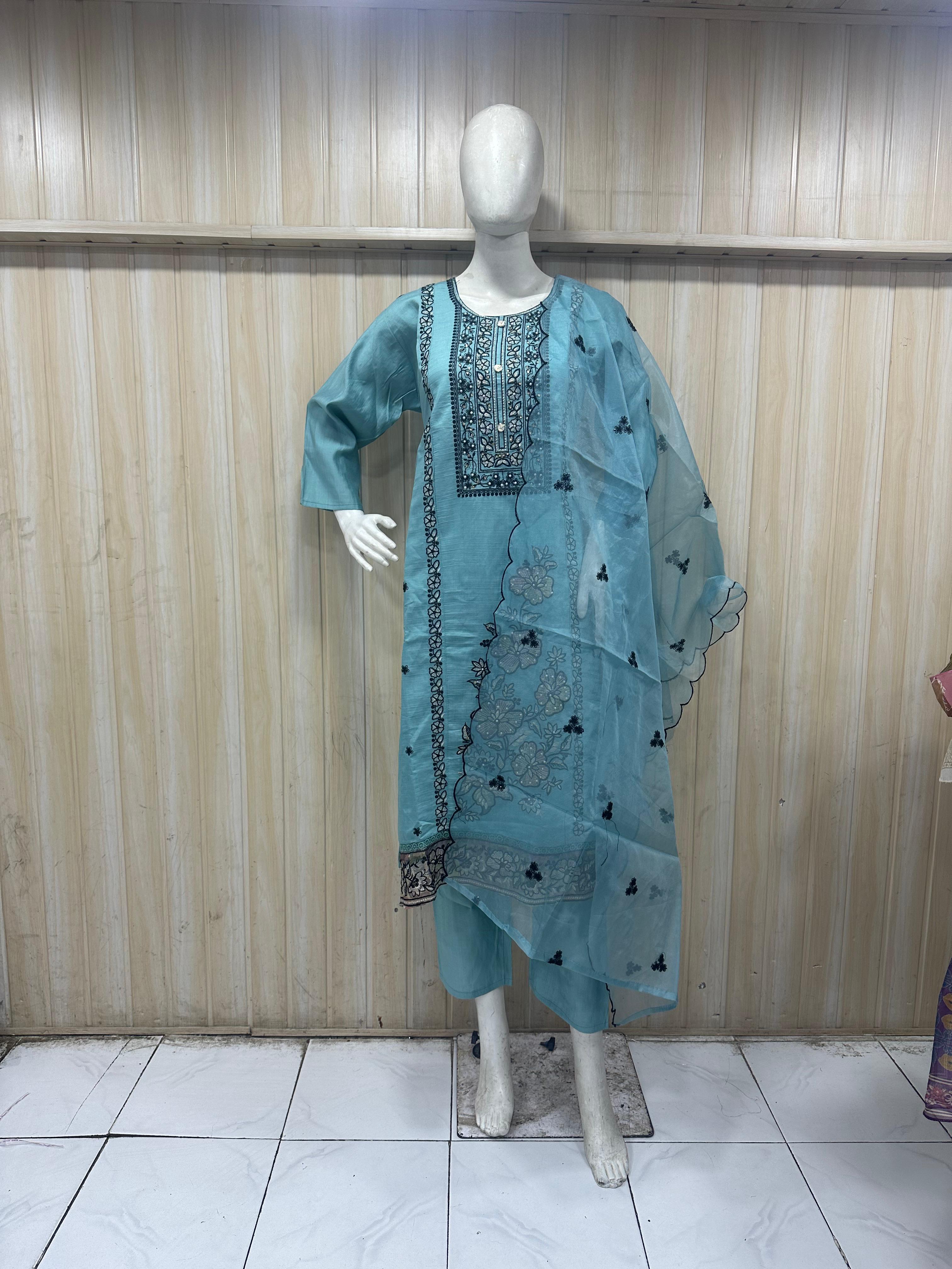 blue and Black traditional outfit with sheer dupatta on a mannequin against a striped