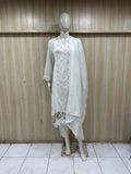 White embroidered outfit on a mannequin against a striped
