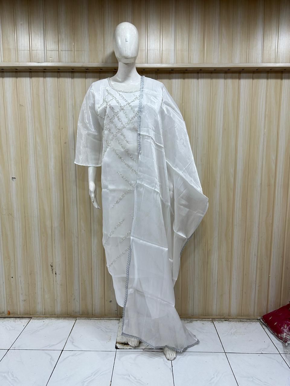 White saree with a mannequin against a striped