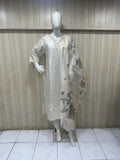 Mannequin wearing a white outfit with floral embroidery against a striped