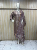 Mannequin wearing a brown floral dress against a striped