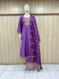Purple traditional outfit with intricate designs on a mannequin against a striped
