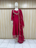 Red traditional outfit with embroidery on a mannequin against a striped