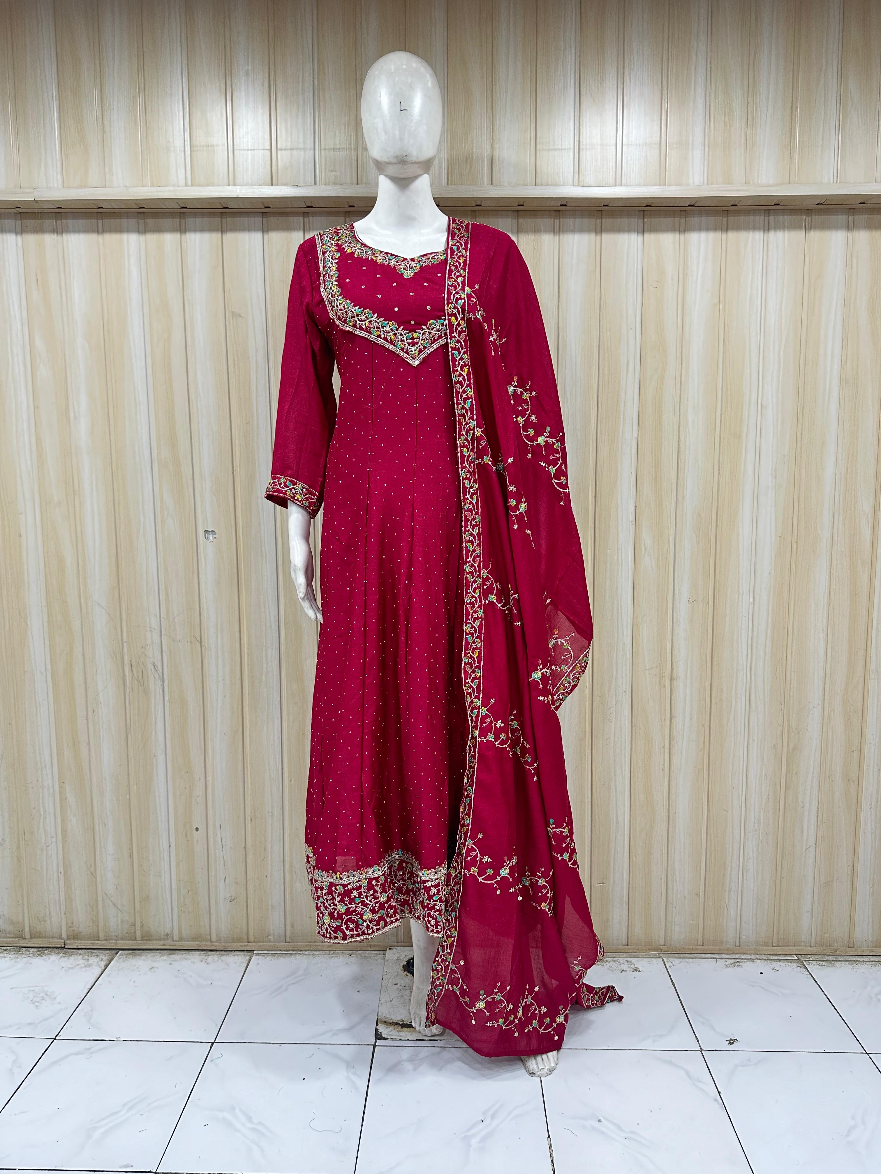 Red traditional outfit with embroidery on a mannequin against a striped