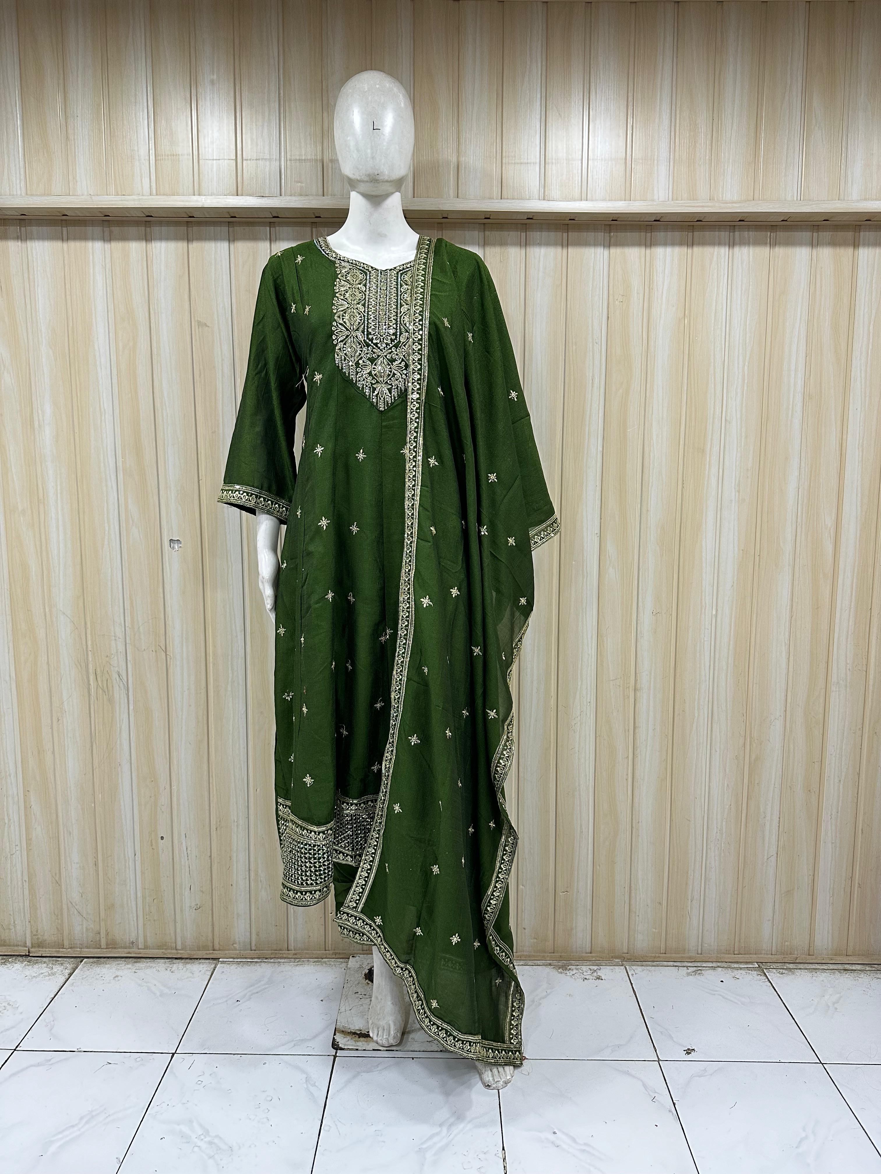 Green traditional outfit with intricate detailing on a mannequin against a striped