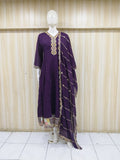 Purple dress with gold embroidery on a mannequin against a striped