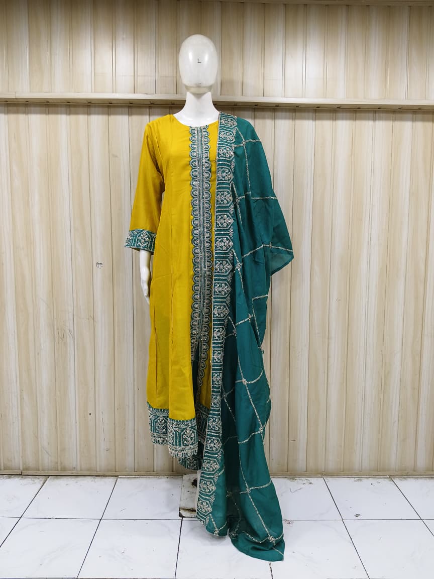 Mannequin wearing a yellow kurta with a green saree against a striped