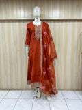 Red traditional outfit with floral patterns on a mannequin against a striped