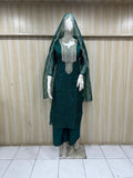 Green embroidered outfit on a mannequin against a striped