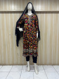 black and malticolore embroidered dress on a mannequin against a striped