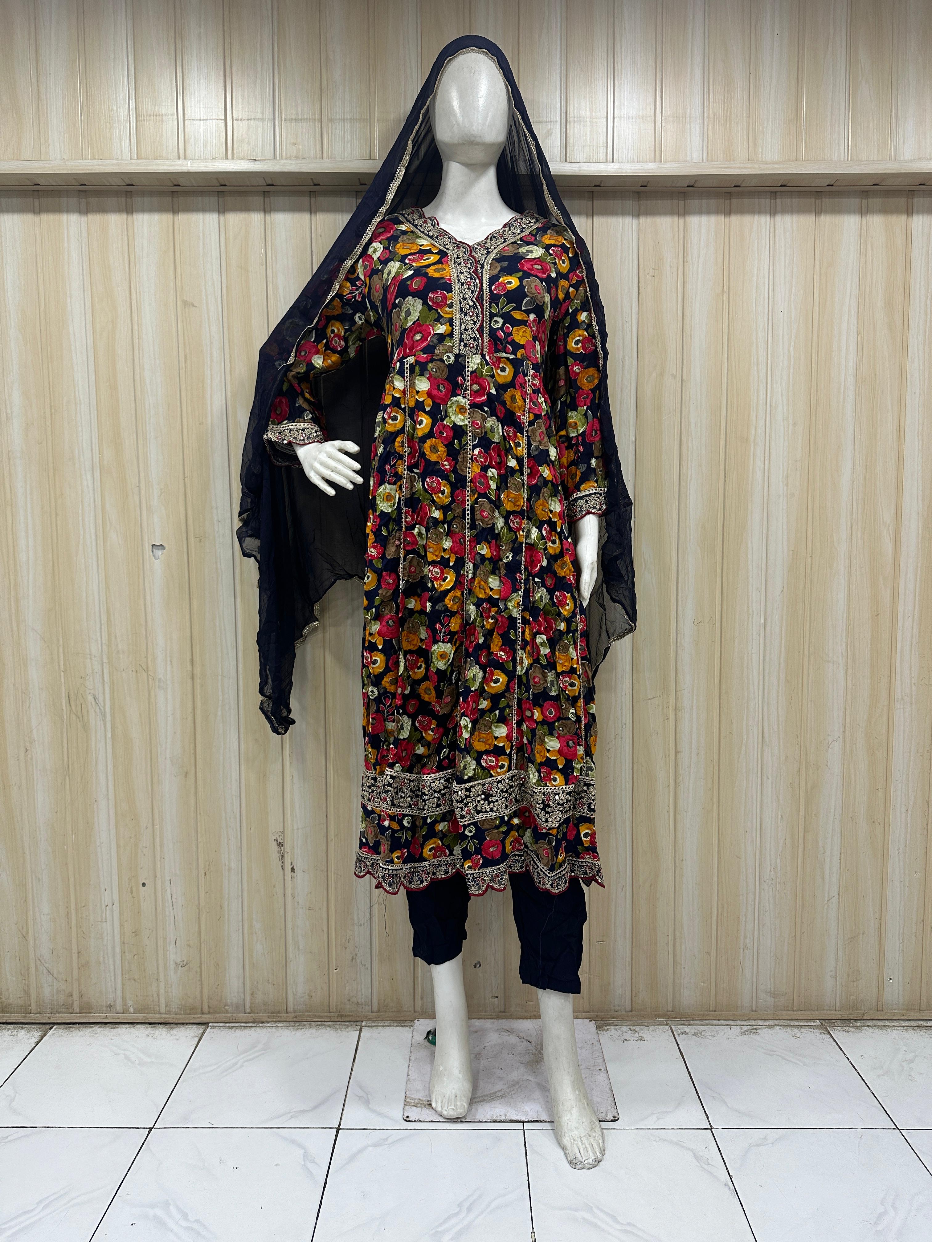 black and malticolore embroidered dress on a mannequin against a striped