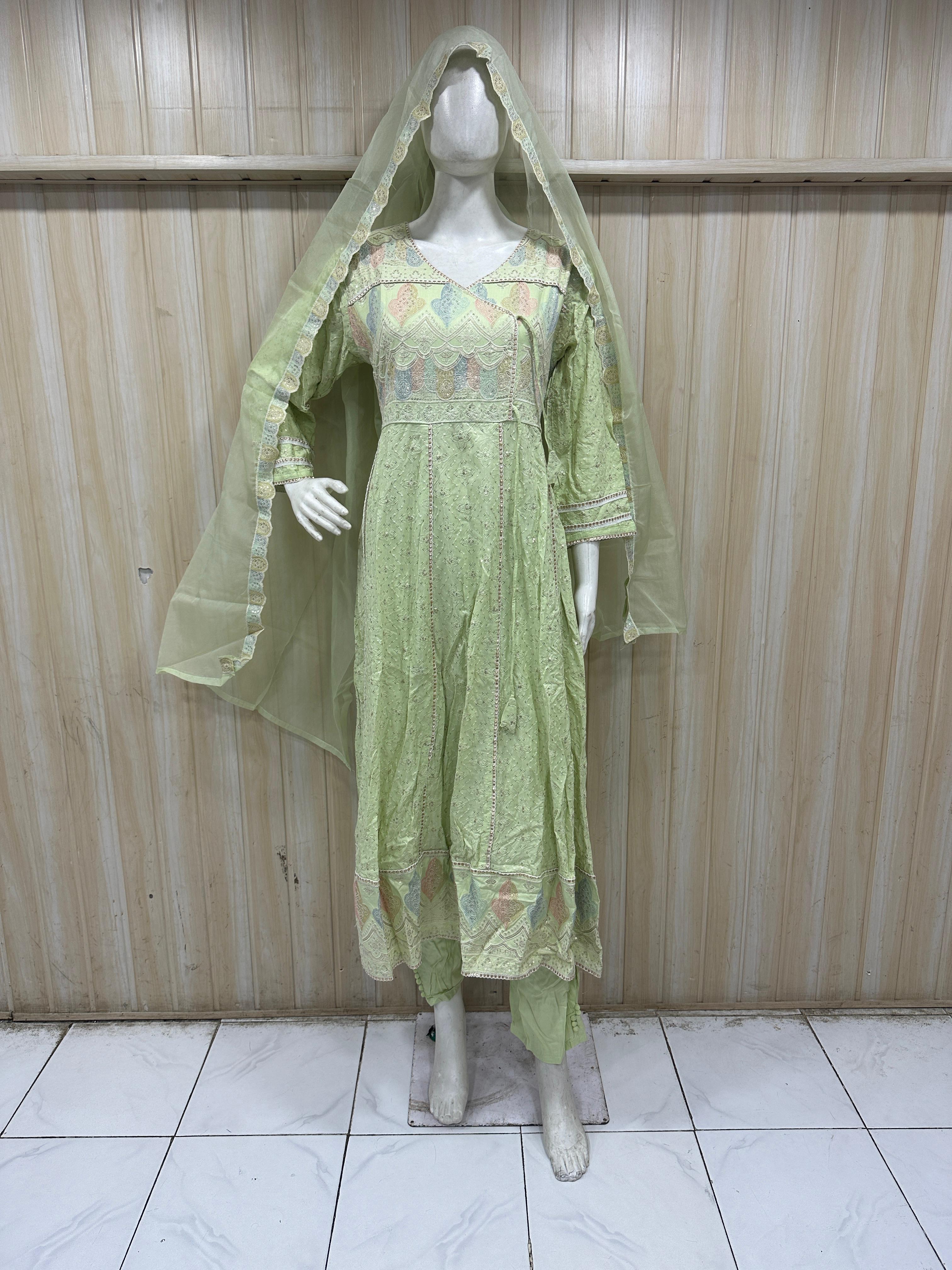 light green traditional outfit with a veil on a mannequin against a striped