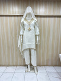 White traditional outfit with embroidered details on a mannequin against a striped