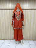 Red traditional outfit with intricate embroidery on a striped