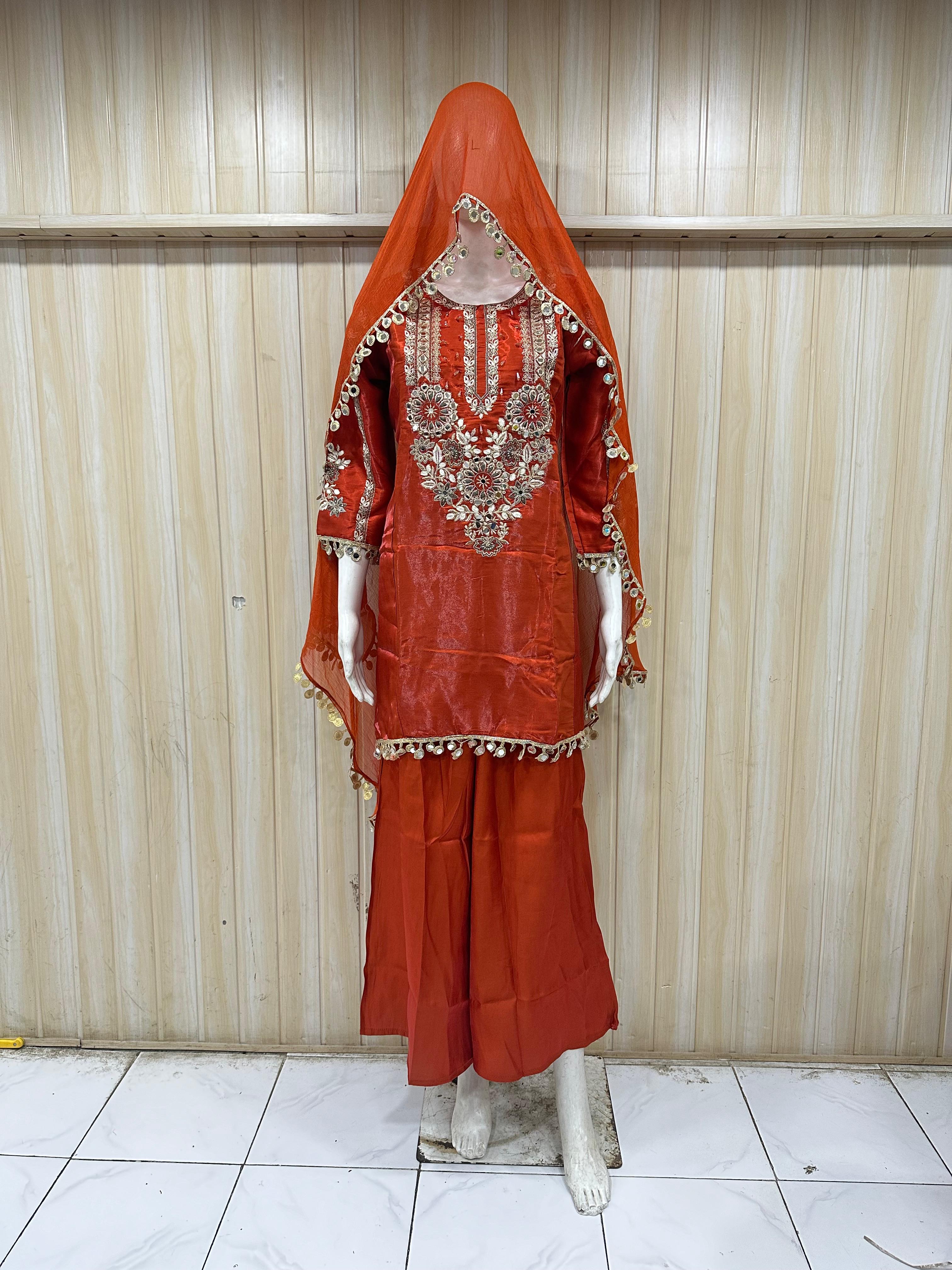 Red traditional outfit with intricate embroidery on a striped