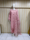 Mannequin wearing a pink dress with floral embroidery against a striped