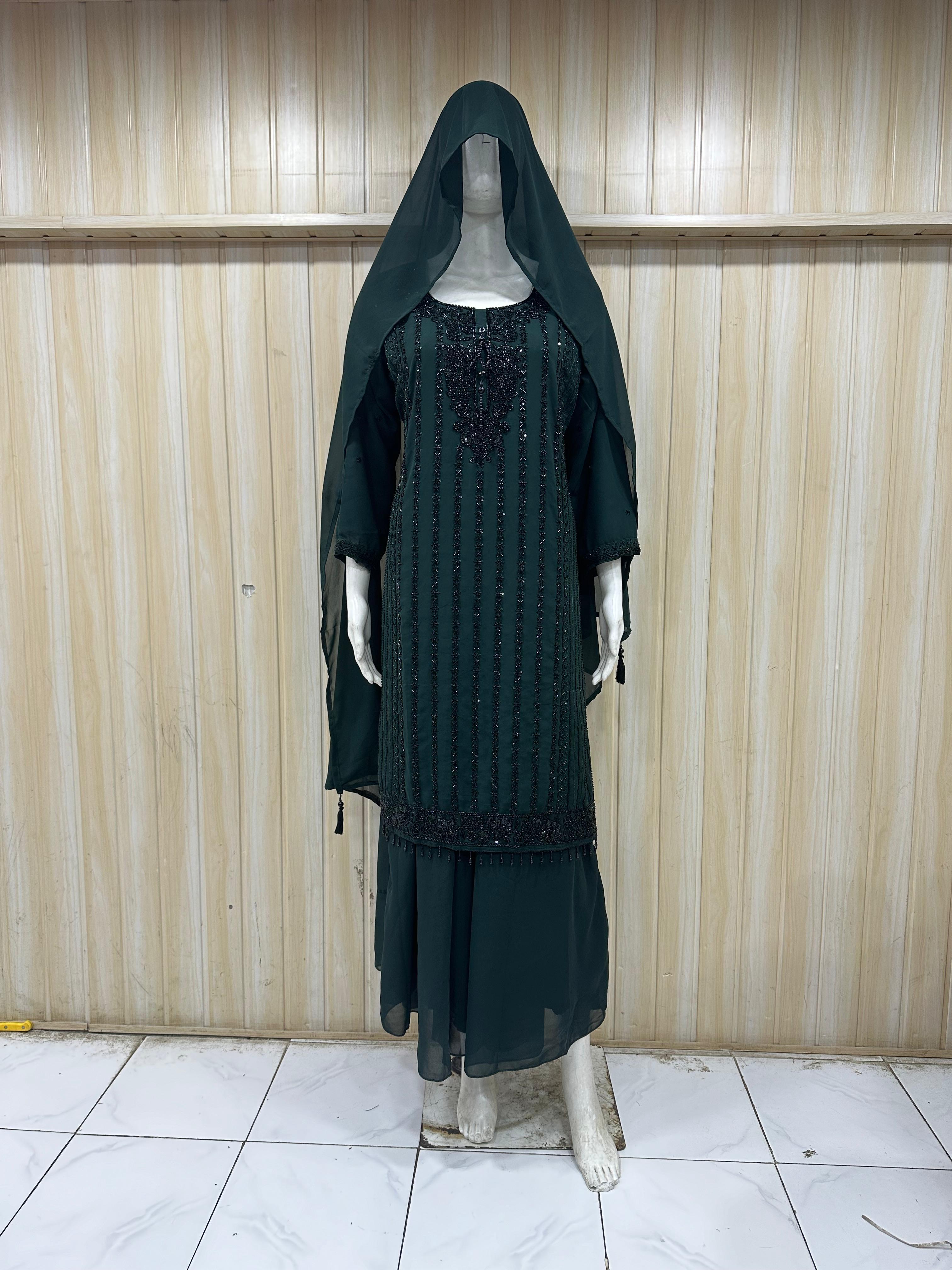 Mannequin wearing a black dress with floral embroidery against a striped
