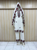 White embroidered outfit with maroon details on a mannequin against a striped