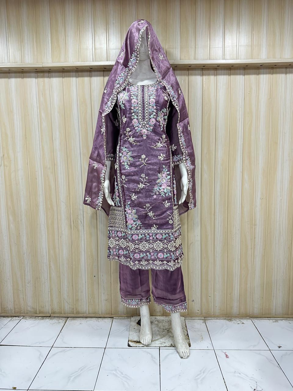 Purple embroidered traditional outfit on a mannequin against a striped