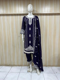 Navy blue embroidered outfit with white patterns on a mannequin against a striped
