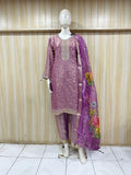 Purple embroidered outfit with a floral dupatta on a mannequin against a striped