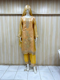 Mannequin wearing a yellow embroidered outfit against a striped